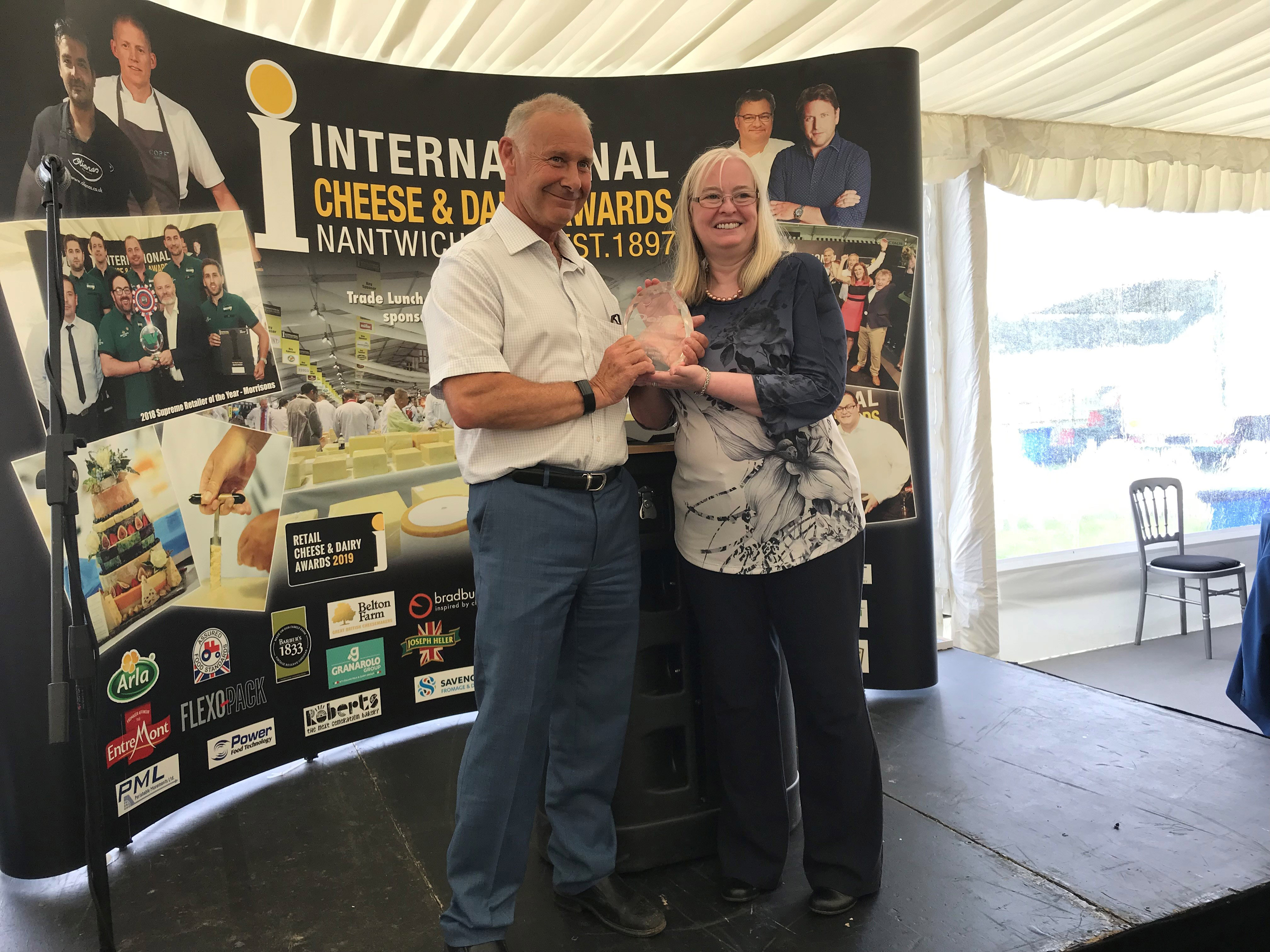 Alan Armstrong receives cheese award from Judith Bryans